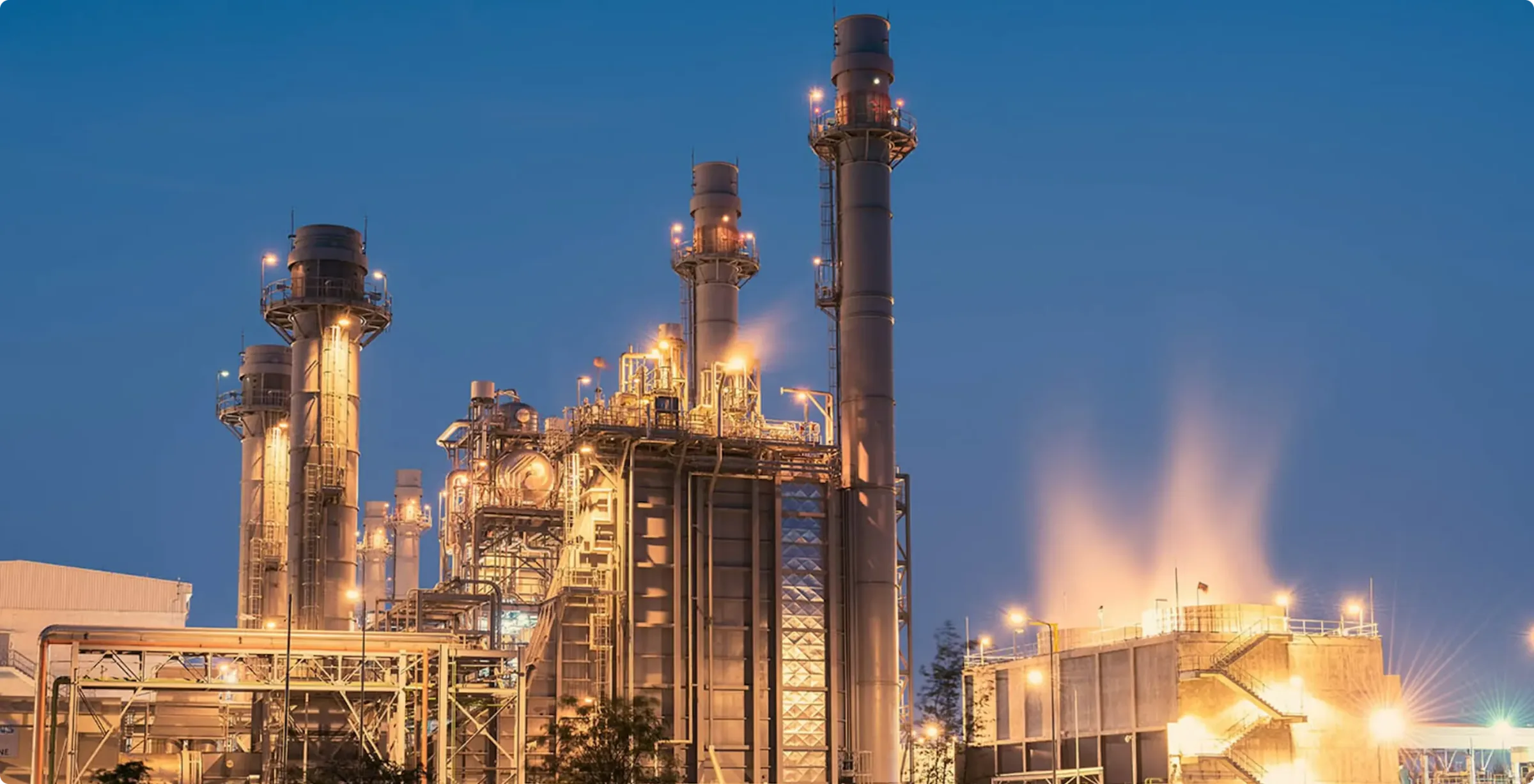 Gas-fired power plant lit up at dusk
